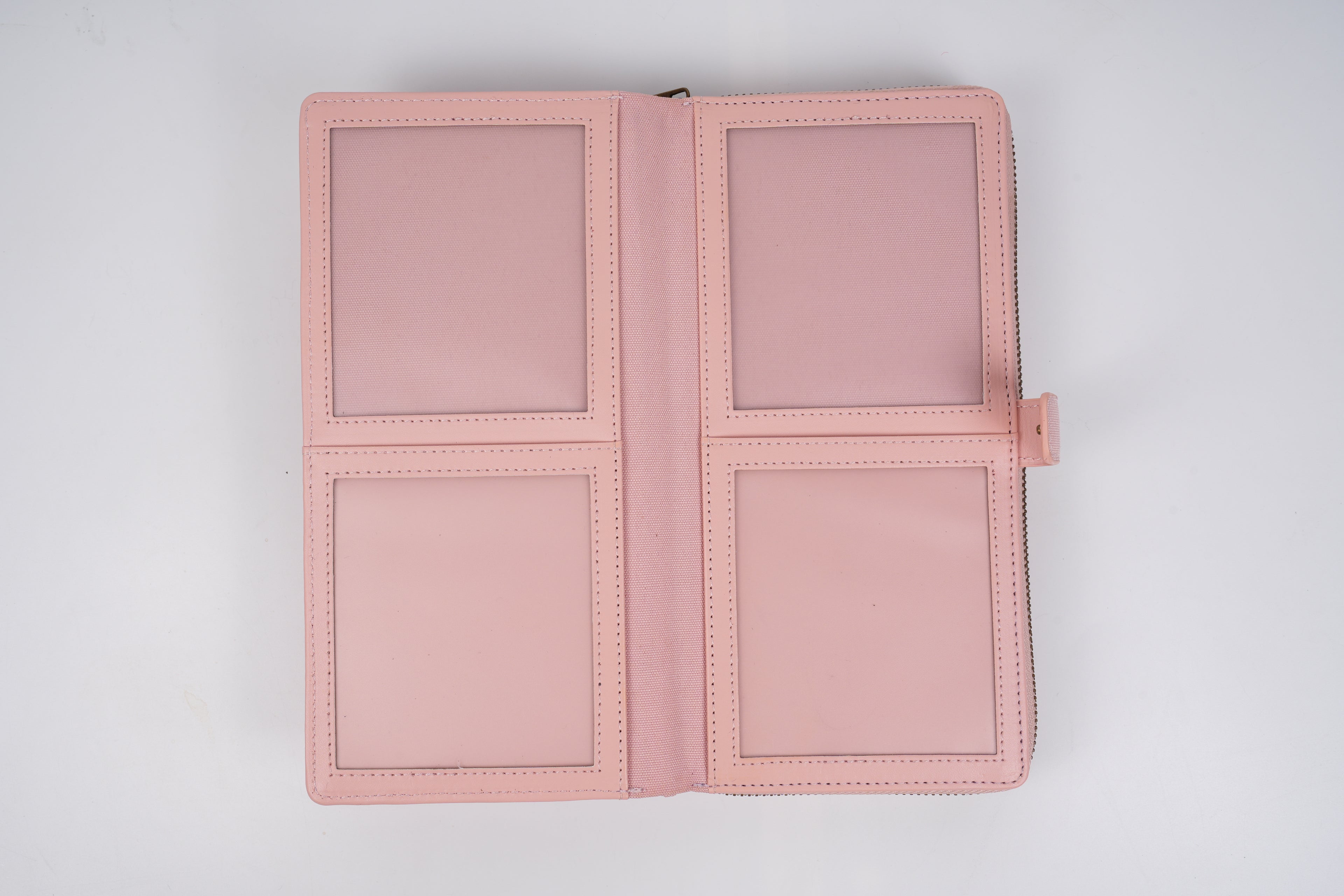 Pink passport holder with multiple compartments on a light gray background